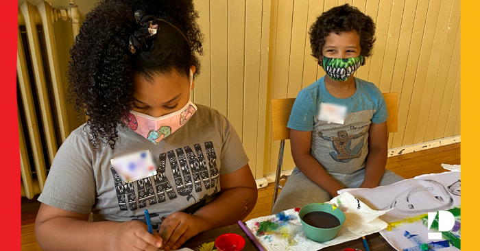 Two children taking part in arts and crafts time at Camp ELSO's Wayfinders Spring Break Camp.