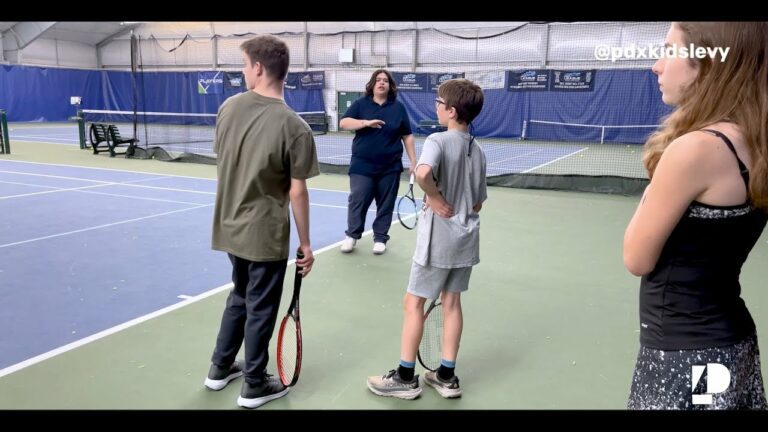 Tennis instructor with youth players on court
