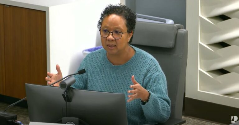 photo of Allocation Committee member Felicia Tripp Folsom seated at a dais during a meeting