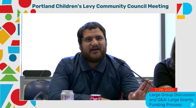 screenshot of July 28, 2025 Community Council meeting with member Deian Salazar seated at a table speaking into a microphone