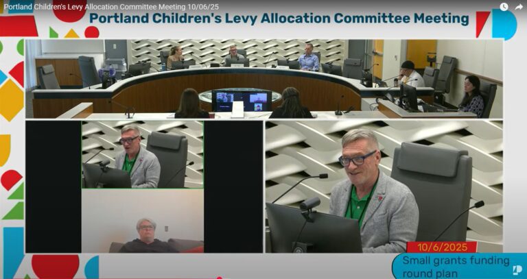 photo from Oct. 6, 2025 Allocation Committee meeting. Councilor Dan Ryan, chair of the Allocation Committee, is seated at a dais in front of a computer monitor and microphone speaking. Ryan is wearing a green shirt and gray jacket.